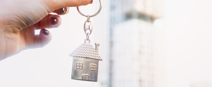 Real estate concept with home keys in hand